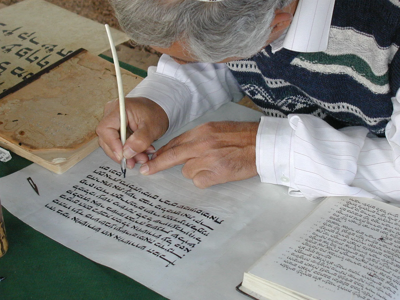 A scribe copying Scripture with a reed pen