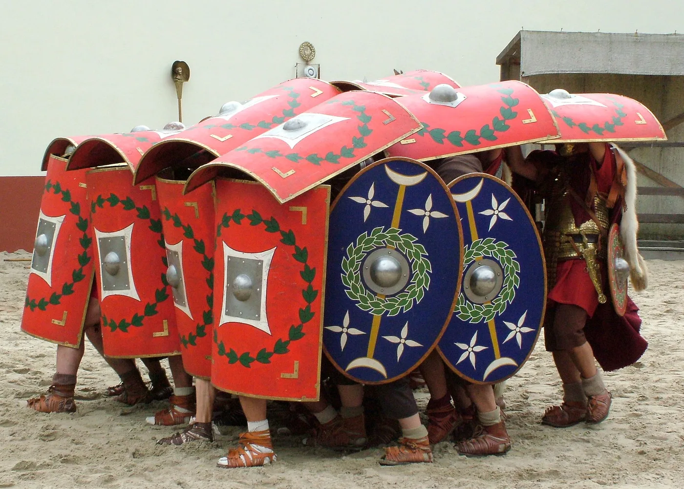 Soldiers form a mantelet with their shields for group protection