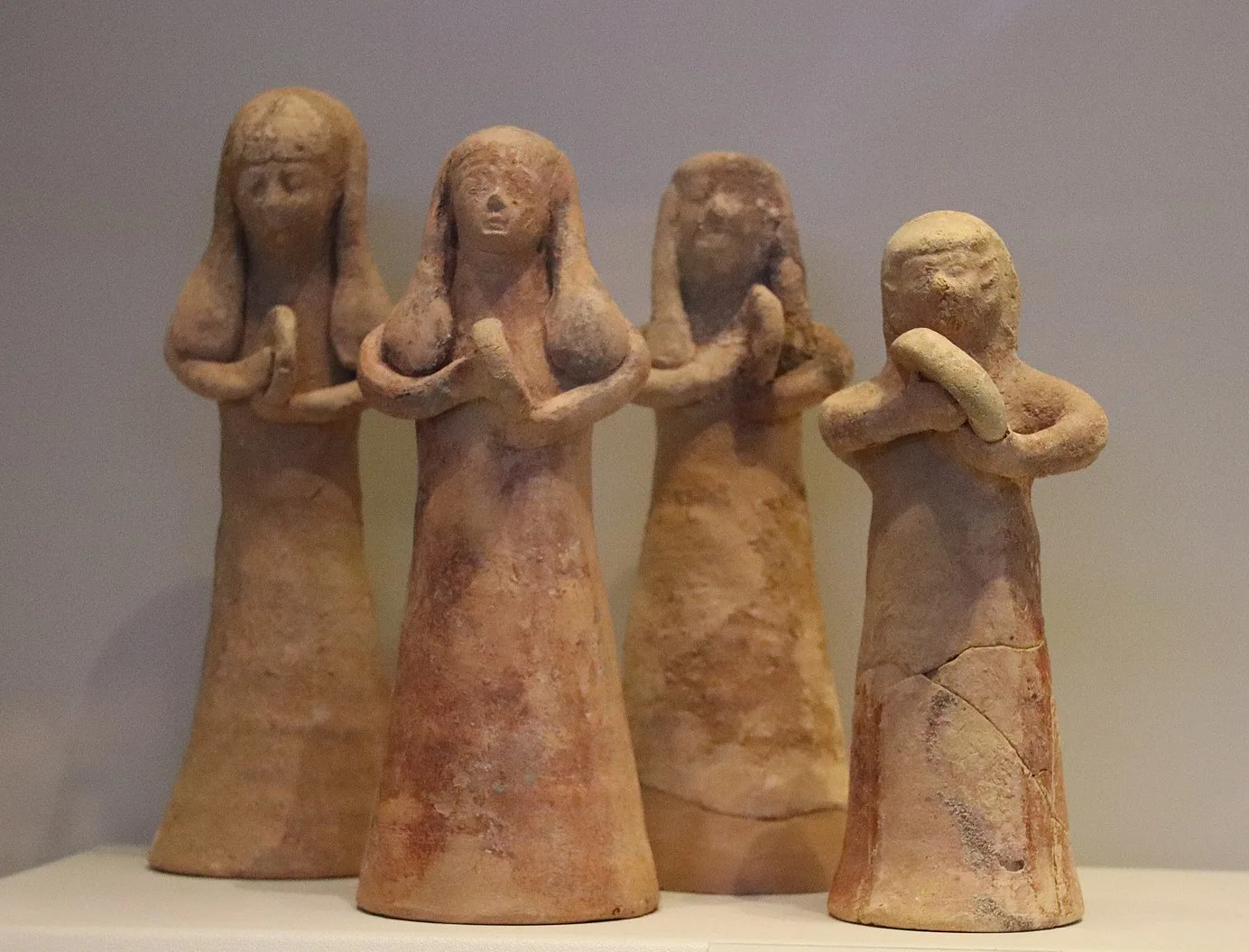 Women beating hand drums